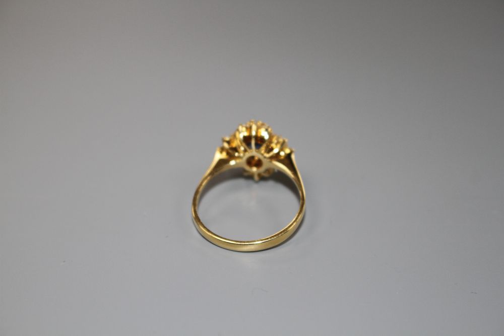 A modern 18ct gold, sapphire and diamonds set quatrefoil shaped cluster ring, size M, gross 4 grams